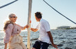 © Artem Varnitsin - Romantic elderly couple sitting on a yacht bow and enjoying their summer journey