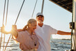 © Artem Varnitsin - Elderly couple enjoying their vacation on a private yacht. Two senior people standing together on a sailboat at sunset.