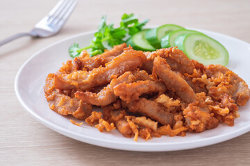 Wall Mural - Fried pork with garlic and pepper on plate, Thai food.