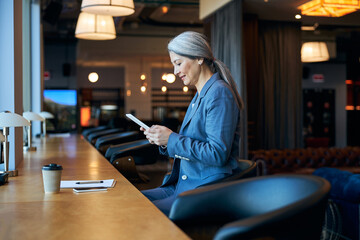 Sticker - Charming woman using tablet computer in cafe