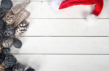 Christmas corner border with silver, bronze and black christmas decorations on white wooden board background. Copy space.