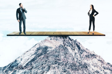 Canvas Print - Two businesspeople standing on wooden board on mountain top.