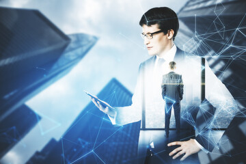 Wall Mural - Businessman holding tablet computer with polygonal interface