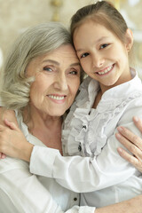 Sticker - Portrait of grandmother with her cute granddaughter smiling