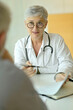 © goodluz - Mature woman doctor in medical consultation with patient
