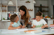 © JustLife - Mother helping her son with homework at home. Little boy learning at home.