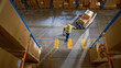 © Gorodenkoff - Top-Down View: Worker Moves Cardboard Boxes using Manual Pallet Truck, Walking between Rows of Shelves with Goods in Retail Warehouse. People Work in Product Distribution Logistics Center