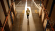 © Gorodenkoff - Top-Down View: Worker Wearing Hard Hat Checks Stock and Inventory Using Digital Tablet Computer in the Retail Warehouse full of Shelves with Goods. Working in Logistics, Distribution