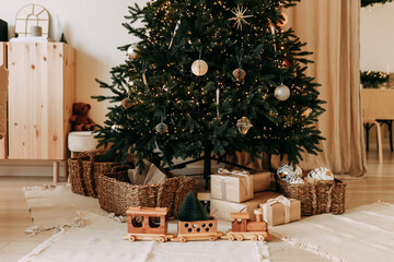 Christmas interior of a bright living room with a large Christmas tree decorated with gifts in a cozy home, dining room