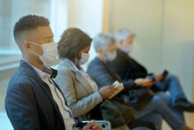 Patients sitting in waiting room with face mask, COVID-19 pandemic