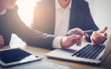 Two businessman using laptop at meeting