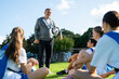 © Rido - Football coach training student players at college