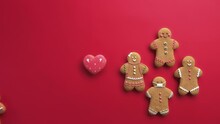Social Diversity. Ethnic Tolerance. Freedom Solidarity. Female Hand Showing Gingerbread Man Crowd Supporting Brown African Gay Cookie With Heart Isolated On Red Conceptual Background Set Of 2.