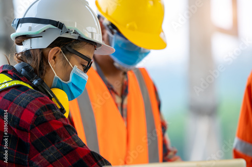 Construction workers wear protective face masks to prevent the spread of Covid 19 by wearing a face mask,Corona virus disease.