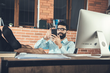 Smiling businessman chatting on mobile phone
