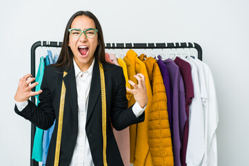 Wall Mural - Young asian designer woman isolated on white background screaming with rage.