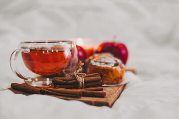 tray at home with autumn drinks and pastries with cinnamon and apples