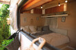 © New Africa - Stylish interior with comfortable bed and pillows in modern trailer, view from outside. Camping vacation