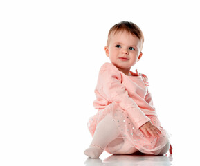 Smiling little baby girl on white floor background