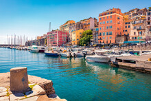 Colorful Houses On The Shore Of Bastia Port. Bright Morning View Of Corsica Island, France, Europe. Magnificent Mediterranean Seascape With Yacht. Traveling Concept Background.