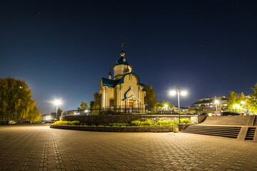 the new chapel is beautifully illuminated with lights at night on a full moon