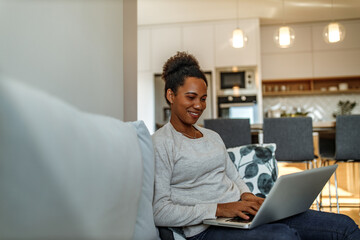 Wall Mural - Woman enjoying at home, kitchen in the background.