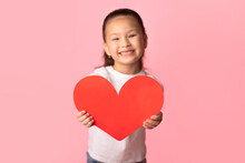 Asian Little Girl Holding Paper Heart In Hands