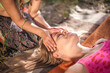 © Mr. Prof - Two women massage each other in the daylight.