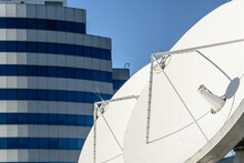 Large Ground Antenna Array With Modern Building In The Background