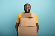 © alphaspirit - Happy man holds a lot of received packages. Cyan background