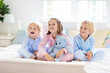 © famveldman - Kids play in bed. Children at home.