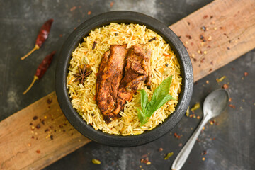 Wall Mural - Arabic chicken Manthi or mandi cooked meat, Basmati rice with Masala, spice. Kuzhimanthi or hot and spicy Manthi on black background in Malabar Kerala, South India. Top view of Indian non veg food.