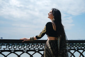 Woman in ethnic indian costume with gold jewellery and traditional makeup.