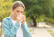 © Pixel-Shot - Young woman suffering from allergy outdoors