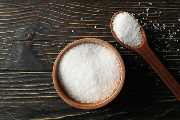 Wall Mural - Spoon and bowl with salt on wooden background