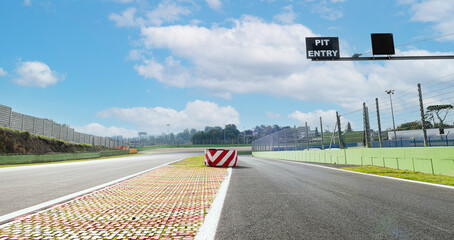 Separation obstacle warning and pit lane entry text board on asphalt track motor sport circuit