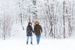 © satura_ - Young couple in love walks in the snowy forest. Active winter holidays.