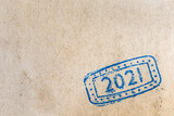 Fototapeta  - Ink stamp 2021 on sheet of rustic brown paper