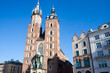 Krakow, Poland - February 17, 2019: Old city center view with Adam Mickiewicz monument and St. Mary's Basilica in Krakow