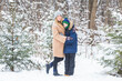 © satura_ - Portrait of happy mother with child son in winter outdoors. Snowy park. Single parent.
