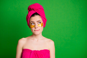 Poster - Lady look up unsure use under eyes patches have difficult choice wear towels body head isolated green color background