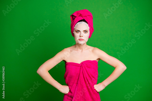 Photo of mad lady apply facial mask hands by sides bad mood wear towels body head isolated green color background