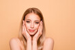 © deagreez - Portrait of positive cheerful satisfied youth person touch cheeks face head hands palms feel content candid visit cosmetologist have rejuvenation ideal skin concept she isolated on grey background