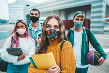 Portrait Of A Group Of Students Covered By Face Masks. New Normal Lifestyle Concept With Young People Going To School At Corona Virus Pandemic.