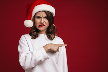 Wall Mural - Sad young woman in christmas santa hat