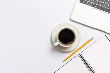 Top view white office desk with notebook, Laptop computer and Coffee cup with ,office supplies on white background