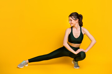 Wall Mural - Full length body size view of her she nice attractive focused cheery girl doing physical exercise shaping isolated on bright yellow color background