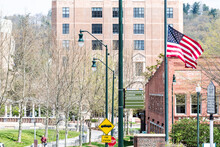 Asheville, USA - April 19, 2018: Buildings, Courthouse And Green Pack Square Park In North Carolina NC Famous Town, City In The Mountains, Sign, Flag