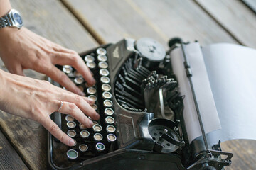 man typing on a typewriter