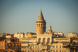 Fototapeta  - Galata Tower and Sun. Cityscape of Istanbul at sunset. Istanbul sunset background photo. Travel to Istanbul. 